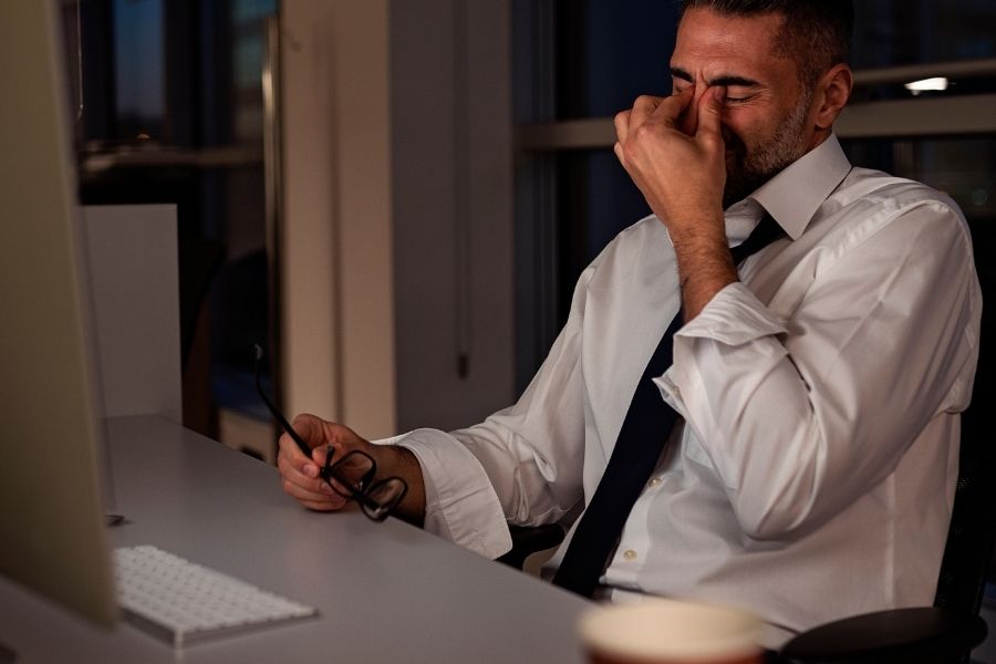 mature man working late night in office