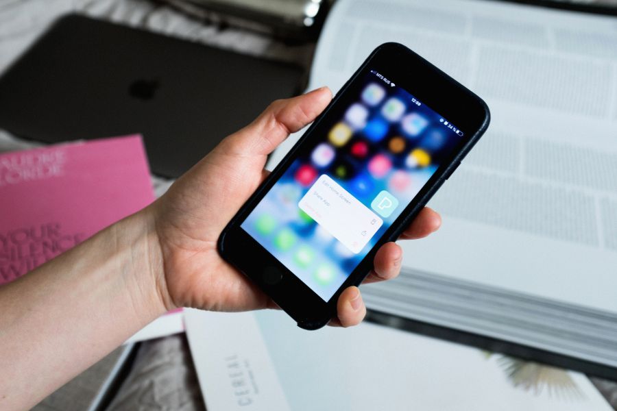 person holding a smartphone Crop faceless person showing pop up window on smartphone screen